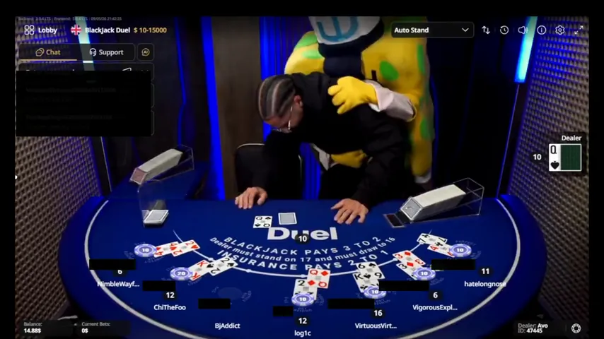 The costume leaning over the host with both arms around him at the Duel Blackjack table